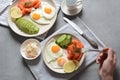 Healthy breakfast concept, fried eggs, avocado and smoked salmon