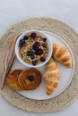 Healthy breakfast concept. Granola with berries, croissants and Royalty Free Stock Photo