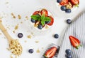 Healthy Breakfast Concept. Muesli with Greek Yogurt, Strawberries and Blueberries