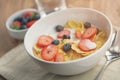 Healthy breakfast with corn flakes and berries in white bowl Royalty Free Stock Photo