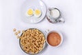 A healthy Breakfast of corn flakes, eggs, milk and tea on a white table Royalty Free Stock Photo