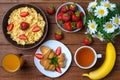 Healthy breakfast: corn flakes, strawberries, juice, tea and croissant. Royalty Free Stock Photo