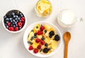 Healthy breakfast with cornflakes, raspberries, blackberries, blueberries, milk and coffee on a white background Royalty Free Stock Photo