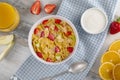 Healthy breakfast cornflakes and strawberries with milk, yogurt and orange juice. Royalty Free Stock Photo