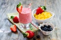 Healthy breakfast with cornflakes, strawberry smoothie and blueberries