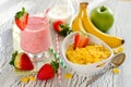 Healthy breakfast with cornflakes, strawberry smoothie and fruit