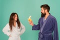 Healthy breakfast. Couple sleepy faces domestic clothes eat banana. Couple in love bathrobes. Advice relationships