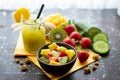 Crispy muesli with fresh strawberries, kiwi and mango with delicious green smoothie in a jar