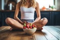 Healthy breakfast. Cropped image of young woman sitting in the kitchen at home, Athletic woman eating a healthy bowl of muesli Royalty Free Stock Photo