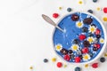 Healthy breakfast diet dessert. smoothie bowl made of blue spirulina, frozen banana, berries and coconut with flowers Royalty Free Stock Photo