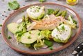 Eggs poached on toast with avocado, asparagus and chicken fillet on grill. Royalty Free Stock Photo