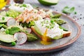 Eggs poached on toast with avocado, asparagus and chicken fillet on grill. Royalty Free Stock Photo