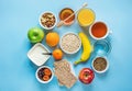 Healthy Breakfast Fiber Sources Digestion Oatmeal Honey Fruits Apples Banana Orange Juice Water Green Tea Nuts. Light Blue Table