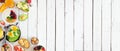Healthy breakfast food banner with table scene side border of fruit, yogurt, smoothie, nutritious toasts and egg skillet over a wh