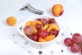 Healthy breakfast, food for children, fruit salad with peaches, pear, grapes on a bright table. The concept of healthy and natural