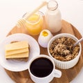 healthy breakfast fresh cereal, cheese sandwich, hard boiled egg, milk bottle, coffee cup and honey jar Royalty Free Stock Photo