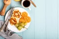 Healthy breakfast with fresh hot waffles hearts, pancakes flowers