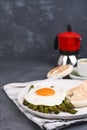 Healthy breakfast. Fried eggs, asparagus, bread and aromatic coffee on a gray background. Free place for text. Soft Royalty Free Stock Photo