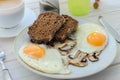 Healthy breakfast, fried eggs with mushrooms and two slices of r Royalty Free Stock Photo