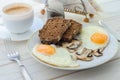 Healthy breakfast, fried eggs with mushrooms and two slices of r Royalty Free Stock Photo