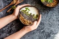 Healthy breakfast of fruit in a bowl of coconut, the girl holds in the palm, bali bowls, indonesia bali