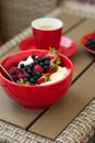 Healthy breakfast on garden furniture: cottage cheese with sour cream, strawberry, raspberry and blueberry, espresso Royalty Free Stock Photo