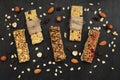 Healthy Breakfast-granola bars with berries and nuts on a dark wooden background.