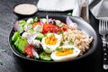 Greek inspired savory oatmeal with fresh cucumber, tomatoes, olives, lettuce, mozzarella cheese and boiled egg