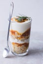 Healthy breakfast. Greek yogurt, salted caramel, crumble, on stone white table