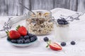 Healthy breakfast with homemade yoghurt and fresh strawberries and blueberries  muesli on a white wooden table in rustic style Royalty Free Stock Photo