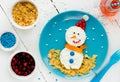 Healthy breakfast idea for kids - christmas snowman from cottage cheese and corn flakes Royalty Free Stock Photo