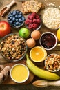 Healthy breakfast ingredients, food frame. Granola, egg, nuts, fruits, berries, toast, milk, yogurt, orange juice Royalty Free Stock Photo