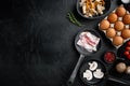 Healthy breakfast ingredients for fried eggs in cast iron frying pan  on black background  top view flat lay   with space for text Royalty Free Stock Photo