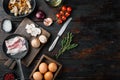 Healthy breakfast ingredients for fried eggs, on old dark  wooden table background, top view flat lay , with space for text Royalty Free Stock Photo