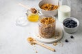 Homemade granola with raisin, seeds, hazelnut and peanut in glass jar, milk or yogurt bottle, honey and blueberriesd. Royalty Free Stock Photo