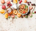 Healthy breakfast ingredients. Oat granola in bowl with nuts, strawberry and mint, milk in jug, honey in glass jar Royalty Free Stock Photo