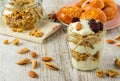 Healthy breakfast ingredients on a white wooden table.