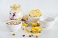 Breakfast in a jar: cereal, banana, fresh berries, granola, yogurt on a light background. The concept of healthy eating, high-carb