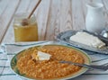 Healthy breakfast with millet porridge with pumpkin, butter and honey. Flat lay Royalty Free Stock Photo