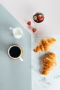 Healthy Breakfast Morning Concept. Two croissants, bowl with strawberry and cup of coffee Royalty Free Stock Photo