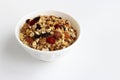 Healthy Breakfast-muesli with berries and nuts in a white plate on a white background. Royalty Free Stock Photo