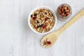 Healthy Breakfast-muesli with berries and nuts in a white plate on a white background. Royalty Free Stock Photo