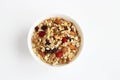 Healthy Breakfast-muesli with berries and nuts in a white plate on a white background. Royalty Free Stock Photo