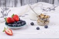 Healthy breakfast with muesli and fresh strawberries and blueberries  milk on a white wooden table in rustic style  close-up Royalty Free Stock Photo