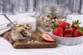 Healthy breakfast with muesli and fresh strawberries and blueberries  milk on a white wooden table in rustic style  close-up Royalty Free Stock Photo