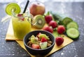 Muesli with fresh strawberries and kiwis with delicious green smoothie in a jar