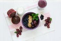 Healthy breakfast: muesli with gooseberry and blackberry, yogurt, blueberry smoothie and chocolate muffins Royalty Free Stock Photo