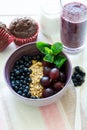 Healthy breakfast: muesli with gooseberry and blackberry, yogurt, blueberry smoothie and chocolate muffins Royalty Free Stock Photo