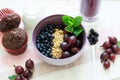 Healthy breakfast: muesli with gooseberry and blackberry, yogurt, blueberry smoothie and chocolate muffins Royalty Free Stock Photo