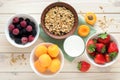 Healthy breakfast with muesli, milk, fruits and berries on white background flat lay, top view